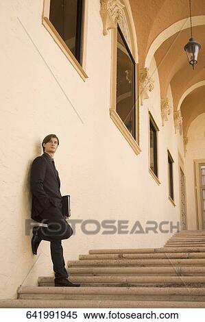 Businessman holding a file on a staircase, Biltmore Hotel, Coral Gables, Florida, USA View Large Photo Image Stock Photography - Businessman holding a file on a staircase, Biltmore Hotel, Coral Gables, Florida, USA. Fotosearch