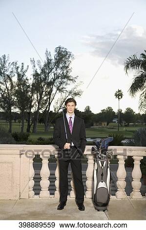 Businessman holding a golf club, Biltmore Golf Course, Biltmore Hotel, Coral Gables, Florida, USA View Large Photo Image Stock Photo - Businessman holding a golf club, Biltmore Golf Course, Biltmore Hotel, Coral Gables, Florida, USA. Fotosearch