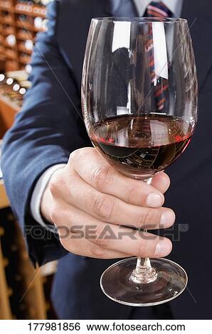 Stock Photograph - Businessman holding a wine glass. Fotosearch
