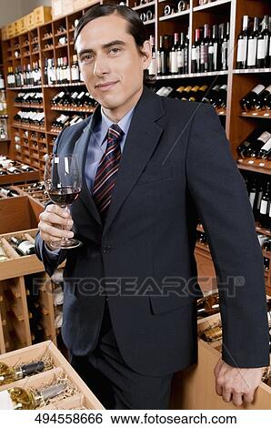 Stock Photograph - Businessman holding a wine glass. Fotosearch