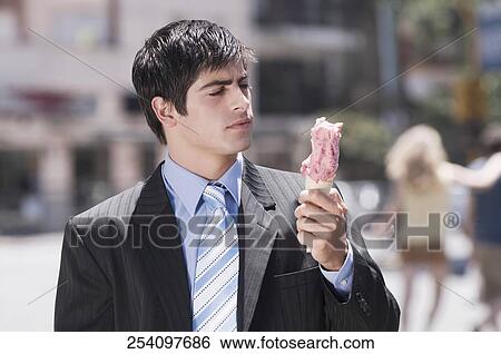 Stock Photograph - Businessman holding an ice cream. Fotosearch