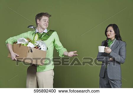 Businessman holding his belongings and a businesswoman holding a cup of coffee View Large Photo Image Stock Image - Businessman holding his belongings and a businesswoman holding a cup of coffee. Fotosearch