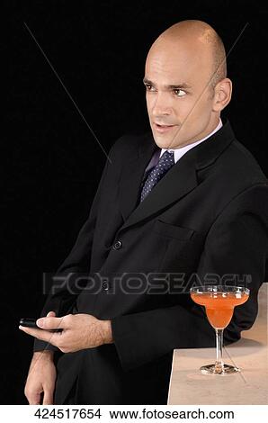 Businessman in a bar View Large Photo Image Picture - Businessman in a bar. Fotosearch