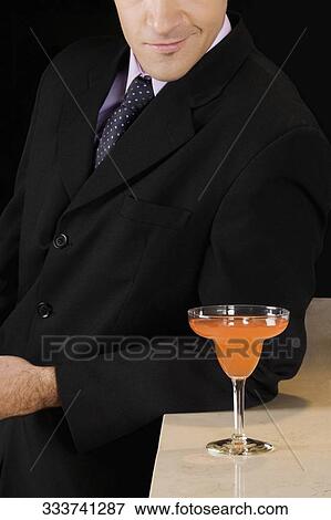Stock Photo - Businessman in a bar. Fotosearch