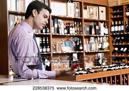 Businessman leaning on a bar counter and holding a rose View Large Photo Image Stock Photography - Businessman leaning on a bar counter and holding a rose. Fotosearch