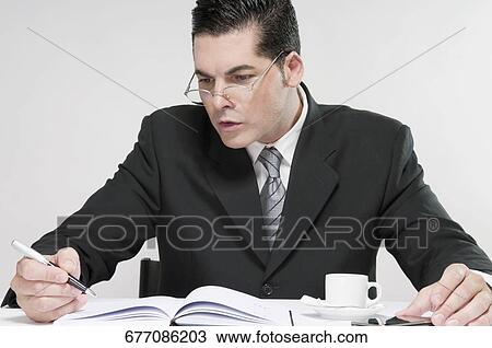 Stock Image - Businessman making notes. Fotosearch