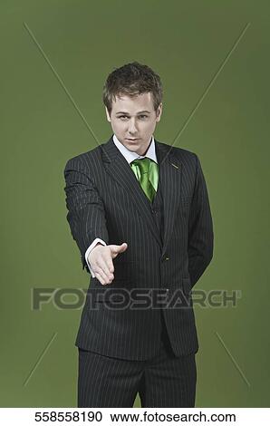 Stock Image - Businessman offering a handshake. Fotosearch