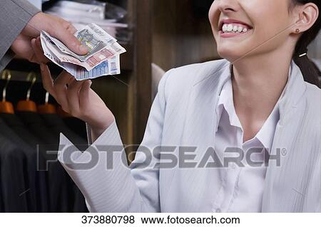 Businessman paying in a clothing store View Large Photo Image Stock Photo - Businessman paying in a clothing store. Fotosearch