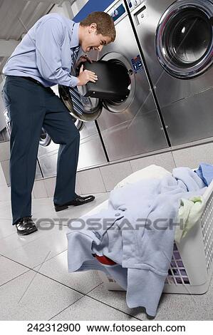 Businessman putting a briefcase into a washing machine View Large Photo Image Stock Image - Businessman putting a briefcase into a washing machine. Fotosearch