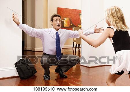 Businessman receiving a warm welcome from his daughter View Large Photo Image Stock Image - Businessman receiving a warm welcome from his daughter. Fotosearch