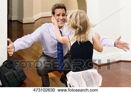 Businessman receiving a warm welcome from his daughter View Large Photo Image Stock Image - Businessman receiving a warm welcome from his daughter. Fotosearch