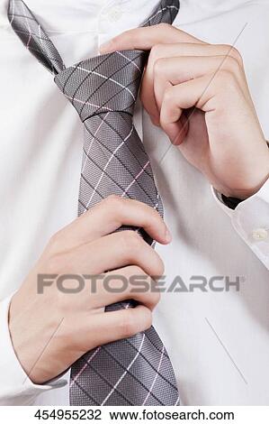 Businessman selecting a tie in a clothing store View Large Photo Image Stock Image - Businessman selecting a tie in a clothing store. Fotosearch
