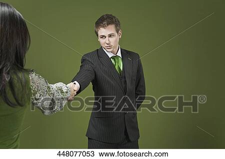 Businessman shaking hands with a businesswoman View Large Photo Image Stock Image - Businessman shaking hands with a businesswoman. Fotosearch