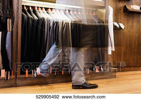 Businessman shopping in a clothing store View Large Photo Image Stock Image - Businessman shopping in a clothing store. Fotosearch