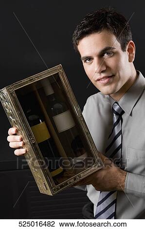 Businessman showing a pair of wine bottles View Large Photo Image Stock Image - Businessman showing a pair of wine bottles. Fotosearch