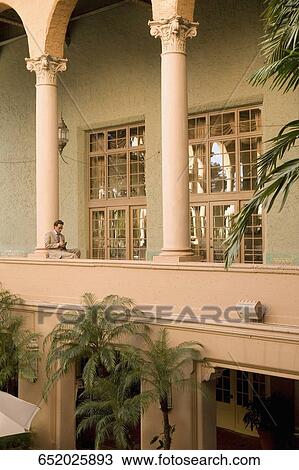 Businessman sitting in the balcony, Biltmore Hotel, Coral Gables, Florida, USA View Large Photo Image Stock Image - Businessman sitting in the balcony, Biltmore Hotel, Coral Gables, Florida, USA. Fotosearch