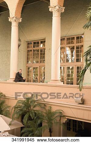 Stock Photography - Businessman sitting in the balcony, Biltmore Hotel, Coral Gables, Florida, USA. Fotosearch