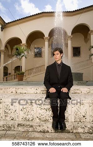 Businessman sitting near a fountain, Biltmore Hotel, Coral Gables, Florida, USA View Large Photo Image Stock Photograph - Businessman sitting near a fountain, Biltmore Hotel, Coral Gables, Florida, USA. Fotosearch