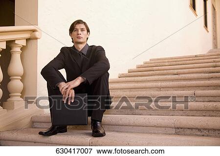 Stock Photo - Businessman sitting on a staircase, Biltmore Hotel, Coral Gables, Florida, USA. Fotosearch