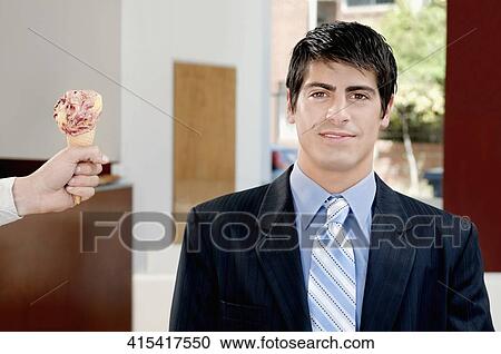 Businessman smiling in an ice cream parlor View Large Photo Image Stock Image - Businessman smiling in an ice cream parlor. Fotosearch
