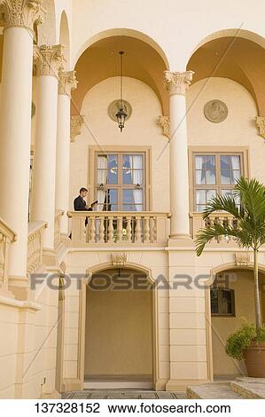 Businessman standing in the balcony, Biltmore Hotel, Coral Gables, Florida, USA View Large Photo Image Stock Image - Businessman standing in the balcony, Biltmore Hotel, Coral Gables, Florida, USA. Fotosearch
