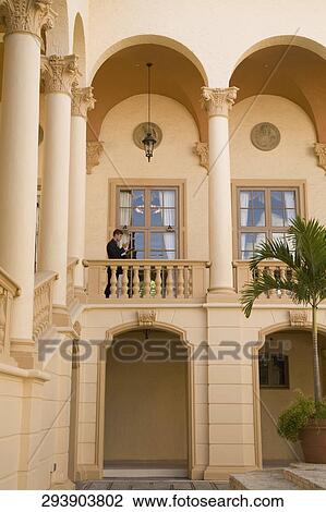 Stock Image - Businessman standing in the balcony, Biltmore Hotel, Coral Gables, Florida, USA. Fotosearch