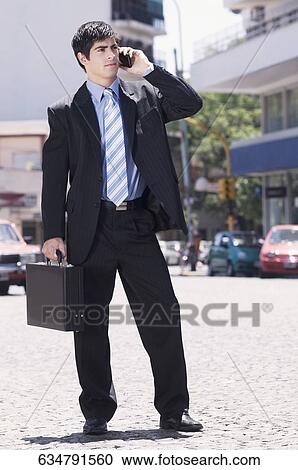 Businessman talking on a mobile phone View Large Photo Image Stock Image - Businessman talking on a mobile phone. Fotosearch