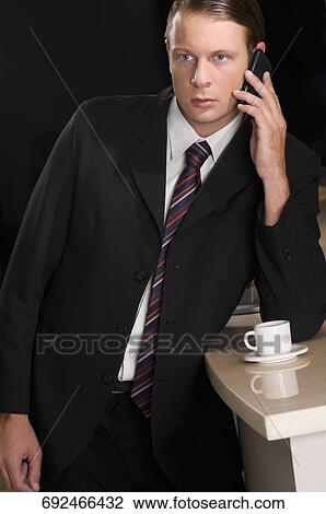 Businessman talking on a mobile phone View Large Photo Image Stock Image - Businessman talking on a mobile phone. Fotosearch