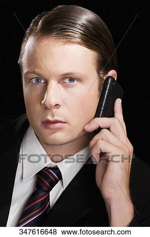 Businessman talking on a mobile phone View Large Photo Image Stock Photo - Businessman talking on a mobile phone. Fotosearch
