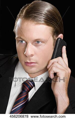 Businessman talking on a mobile phone View Large Photo Image Stock Photo - Businessman talking on a mobile phone. Fotosearch