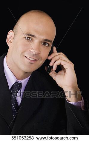 Stock Photo - Businessman talking on a mobile phone. Fotosearch