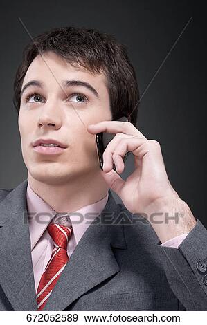 Businessman talking on a mobile phone View Large Photo Image Stock Photo - Businessman talking on a mobile phone. Fotosearch