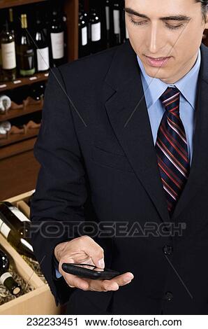 Businessman text messaging on a mobile phone View Large Photo Image Stock Image - Businessman text messaging on a mobile phone. Fotosearch
