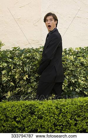 Stock Photo - Businessman urinating in a formal garden and looking shocked, Biltmore Hotel, Coral Gables, Florida, USA. Fotosearch