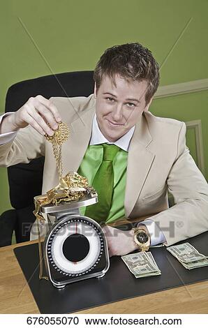 Businessman weighing gold jewelry View Large Photo Image Stock Image - Businessman weighing gold jewelry. Fotosearch