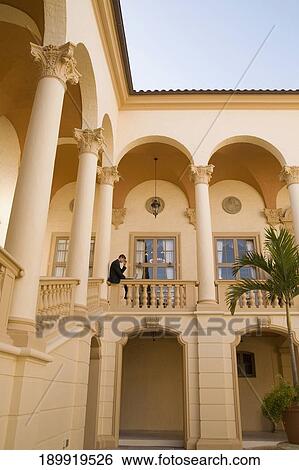 Businessman working on a laptop in the balcony, Biltmore Hotel, Coral Gables, Florida, USA View Large Photo Image Stock Photograph - Businessman working on a laptop in the balcony, Biltmore Hotel, Coral Gables, Florida, USA. Fotosearch