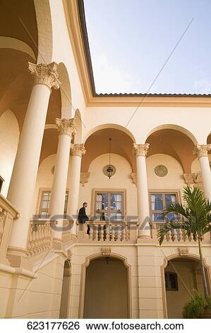 Businessman working on a laptop in the balcony, Biltmore Hotel, Coral Gables, Florida, USA View Large Photo Image Stock Photograph - Businessman working on a laptop in the balcony, Biltmore Hotel, Coral Gables, Florida, USA. Fotosearch