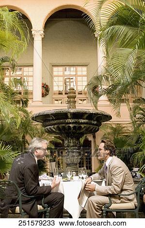 Stock Image - Businessmen at a meeting in a hotel, Biltmore Hotel, Coral Gables, Florida, USA. Fotosearch