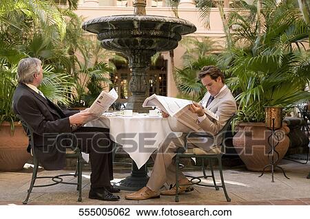 Businessmen reading newspapers in a hotel, Biltmore Hotel, Coral Gables, Florida, USA View Large Photo Image Stock Image - Businessmen reading newspapers in a hotel, Biltmore Hotel, Coral Gables, Florida, USA. Fotosearch