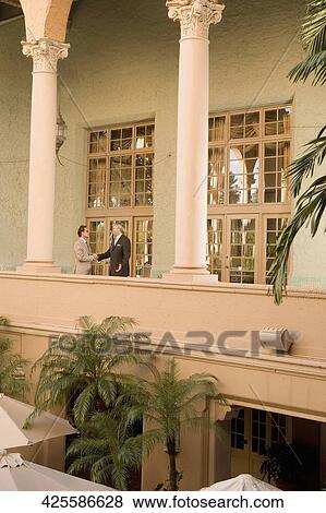 Stock Photo - Businessmen shaking hands in a hotel, Biltmore Hotel, Coral Gables, Florida, USA. Fotosearch