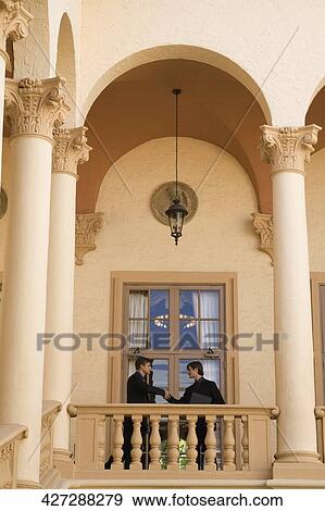 Businessmen shaking hands in a hotel, Biltmore Hotel, Coral Gables, Florida, USA View Large Photo Image Stock Photo - Businessmen shaking hands in a hotel, Biltmore Hotel, Coral Gables, Florida, USA. Fotosearch