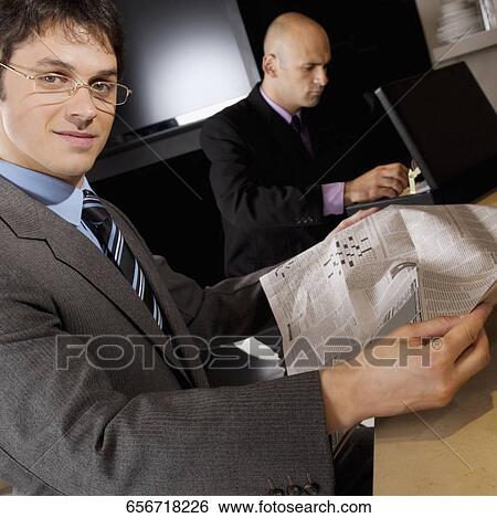 Stock Photograph - Businessmen sitting in a bar. Fotosearch