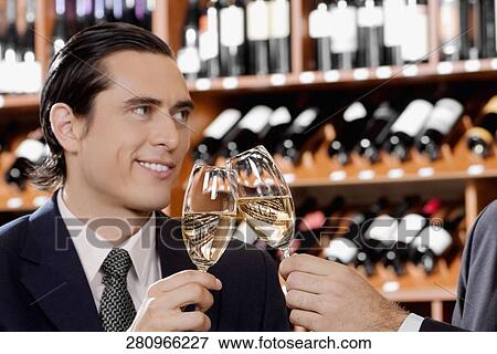 Businessmen toasting with wine View Large Photo Image Stock Photo - Businessmen toasting with wine. Fotosearch
