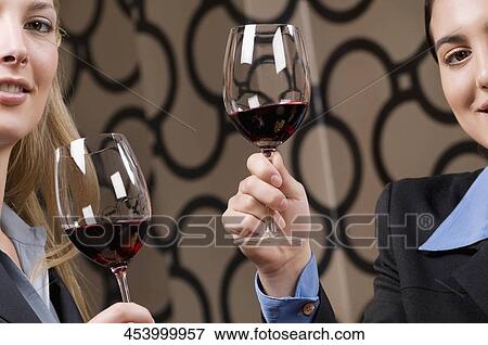 Businesswoman drinking wine and smiling View Large Photo Image Stock Photo - Businesswoman drinking wine and smiling. Fotosearch