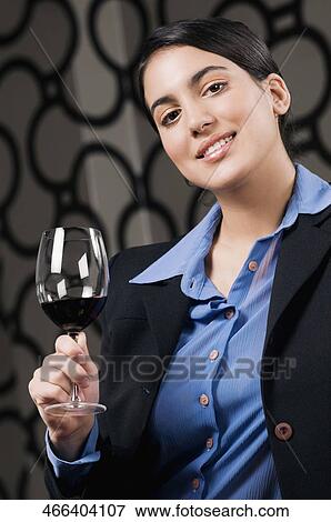 Businesswoman drinking wine and smiling View Large Photo Image Stock Photo - Businesswoman drinking wine and smiling. Fotosearch