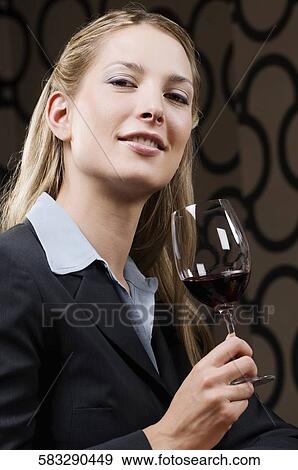 Businesswoman drinking wine and smiling View Large Photo Image Stock Photo - Businesswoman drinking wine and smiling. Fotosearch
