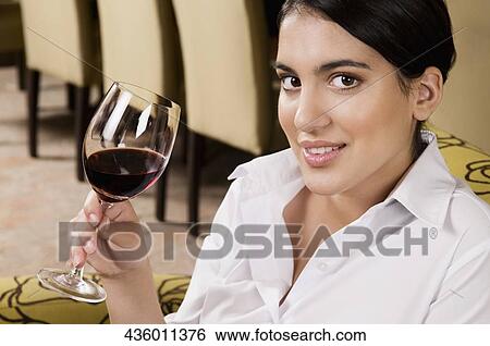 Businesswoman drinking wine and smiling View Large Photo Image Stock Photograph - Businesswoman drinking wine and smiling. Fotosearch