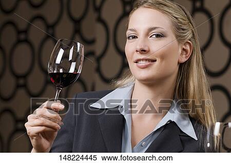 Businesswoman drinking wine and smiling View Large Photo Image Stock Photography - Businesswoman drinking wine and smiling. Fotosearch