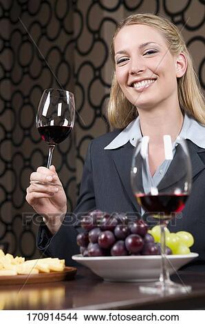 Picture - Businesswoman drinking wine. Fotosearch