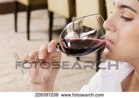 Businesswoman drinking wine View Large Photo Image Stock Photo - Businesswoman drinking wine. Fotosearch